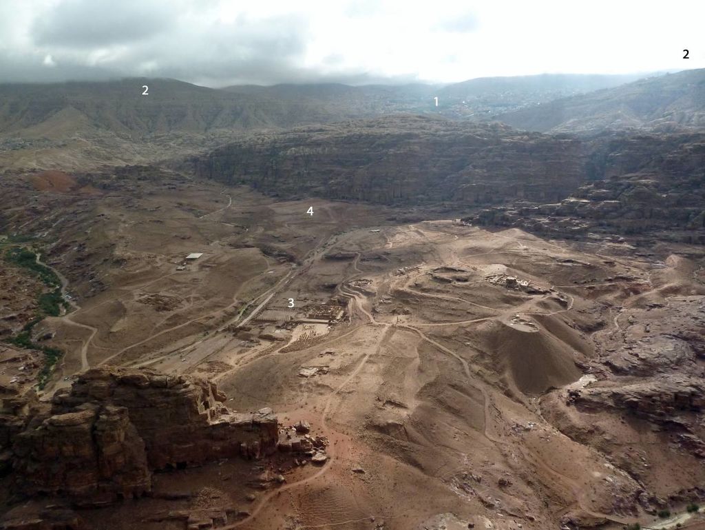 Fig. 1: The city-centre of Petra as seen from Umm al-Biyara. In the background the modern town of Wadi Mousa (1) and the Shara mountains (2). In the centre the South Temple (3) and the area of NEPP (4) (photo: S. G. Schmid)